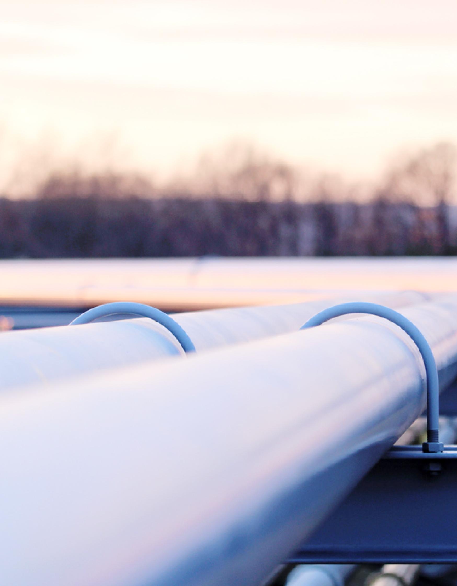 Steel long pipes in crude oil factory during sunset