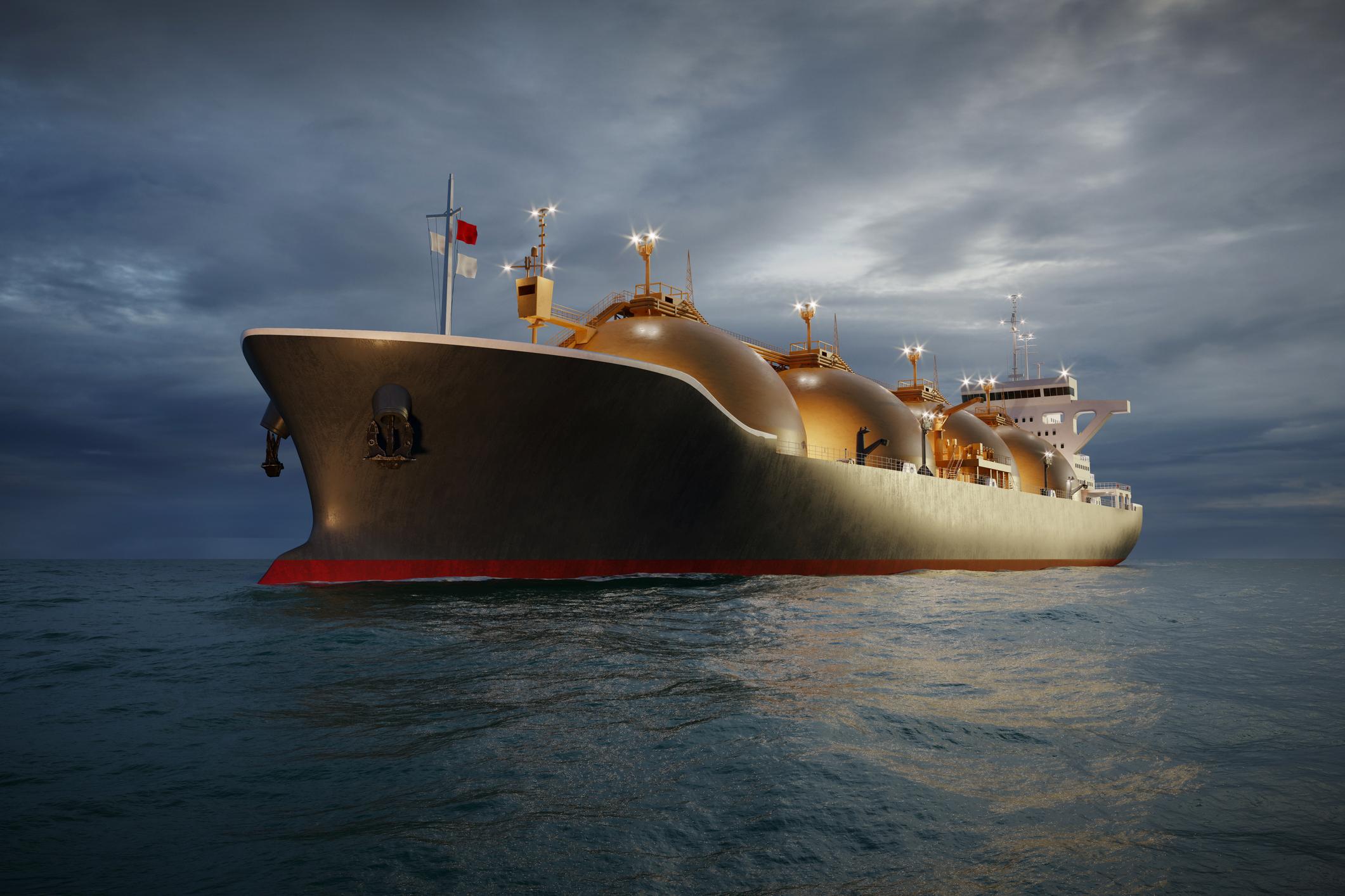 LNG tanker carrier ship sailing in sea at night.