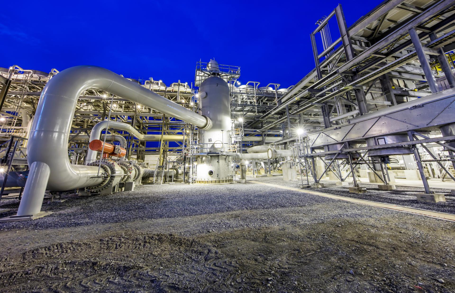 An onshore refinery plant with neon blue sky