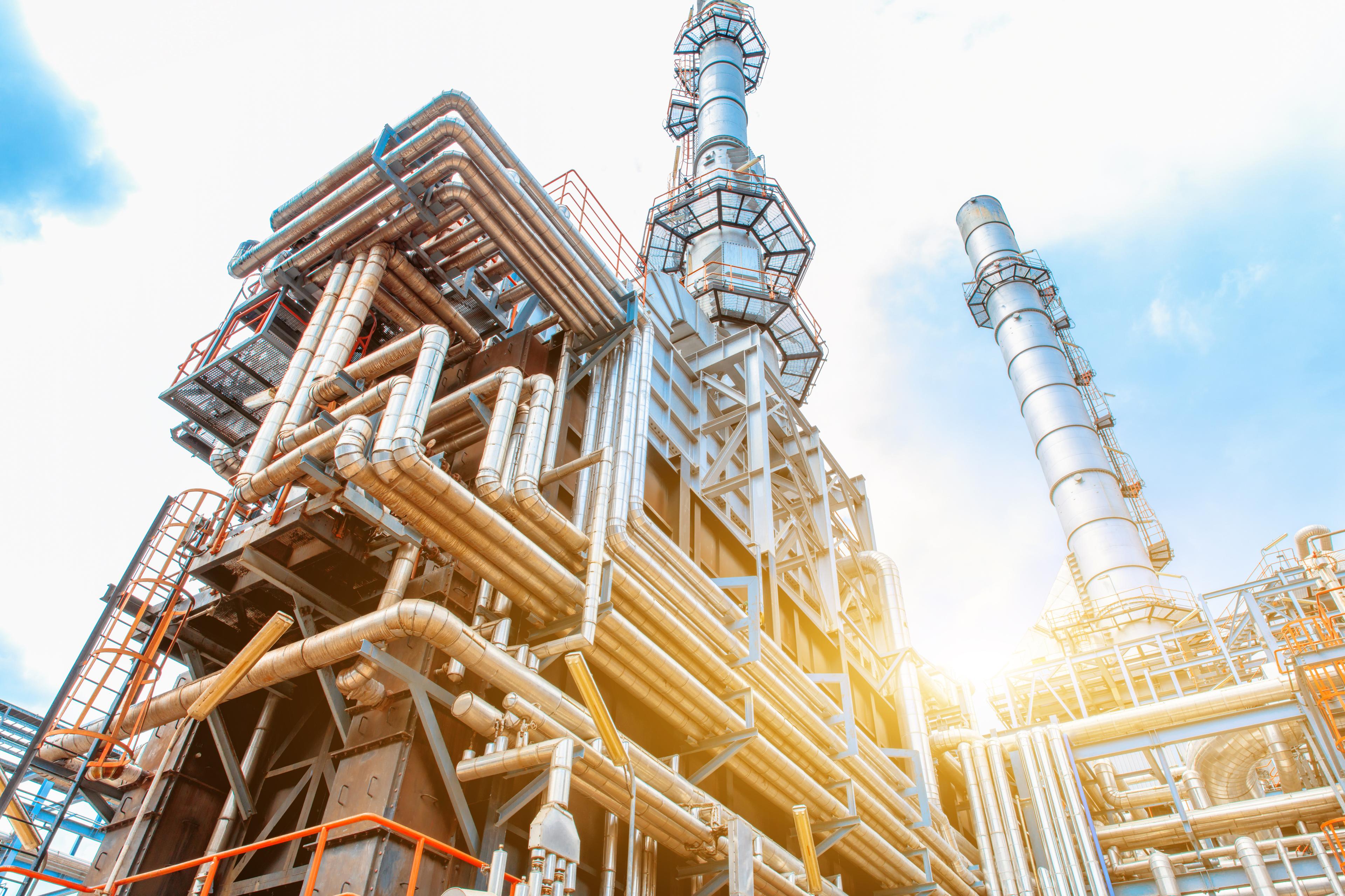 Close-up of pipelines and petrochemical industrial plant towers view of oil and gas refinery